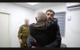 Released hostage Hisham al-Sayed reunites with his father and brother after 10 years.