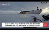 Main image for Transportation Safety Board Crew Investigates Overturned Delta Flight At The Toronto Pearson Airport