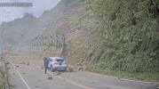 Main image for Car Dodges Death as Massive Boulders Crush Road.