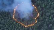 Main image for Firefighters Confront Rare 'Ring of Fire' Blaze in Russian Forest. 