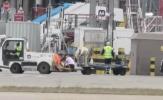 Main image for Man Sprints Across Tarmac Near Moving Plane. 