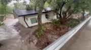 Main image for Heart-Stopping Video: House with Cat Inside Swept Away by Guadalupe River Flood, Slams Into Bridge.