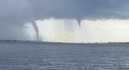 Main image for Captures Stunning Twin Waterspouts at Sea.