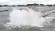 Main image for Monster Waves Crash Over Grand Haven Lighthouse.
