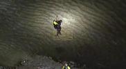 Main image for Heroic Rescue: Firefighter Saves Man Stranded in River Marsh.