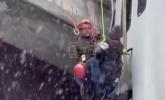 Main image for Firefighters Rescue Driver From Truck Hanging Off Icy Bridge.