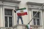 Main image for CLAWING BACK: Protester Replaces Iran Flag with Pre-1979 Lion and Sun in London.