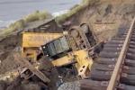 Main image for Storm Damage Sends Excavator Off Rail Line in Deadly California Erosion.