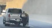 Main image for Video Shows Man Hanging From Moving Truck on Boston Highway.