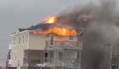 Main image for Firefighters Battle Snow and Cold to Contain House Fire.