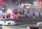 Main image for Chaotic Scene In Queens As Mob Blocks Intersection With Ring Of Fire And Car Drifts Nearby.