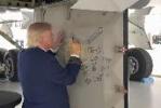 Main image for Trump Signs His Name Into History on New Air Force One's Mechanical Panel.