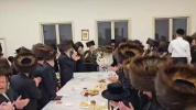 Main image for The Satmar Rebbe Shlit"a writing a letter and dancing with the Sefer Torah at the Hachnosas Sefer Torah last night, Motzei Shabbos, in Camp Satmar Maywood.