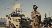 Main image for Hezbollah in Iraq showing off their camouflaged black uniform in the desert.