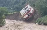 Main image for HOUSE PLUNGES IN: Hillside Home Collapses into Raging Floodwaters During Nepal Disaster