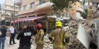 Main image for Emergency Responders on the Scene of a Partially Collapsed Three-Story Building in Tel Aviv, Israel