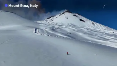 Mount Etna Eruption Continues as Skier Glides Down Slopes.