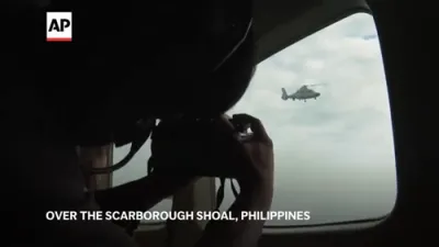 Chinese navy helicopter flies close to Philippine patrol plane over disputed shoal