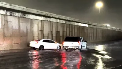 Cars Plow Through Flooded Streets. 