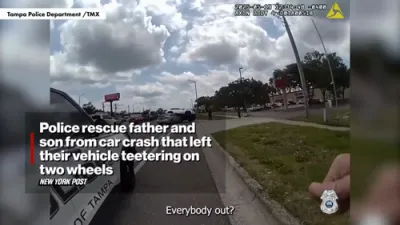 Police Rescue Father and Son from Car Teetering on Two Wheels After Crash in Tampa. 