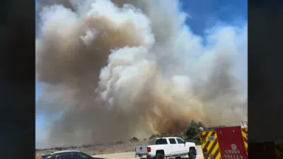 California Firefighters Battle Blaze Burning Near Major Highway.