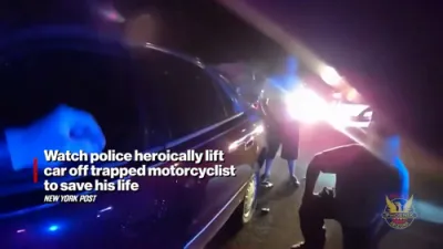Watch: Police and Firefighters Heroically Lift Car Off Trapped Motorcyclist in Phoenix.