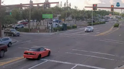 Car Blasts Through Red Light.