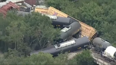 Train Cars Pile on Top of One Another in Fiery Derailment.