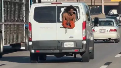 WILDFOOTAGE: Oklahoma Inmate Hangs Out of Prison Van in Daring Escape Attempt.