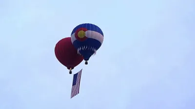 Giant U.S. Flag Soars From Hot Air Balloons.
