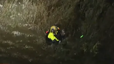Heroic Rescue: Firefighter Saves Man Stranded in River Marsh.
