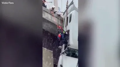 Firefighters Rescue Driver From Truck Hanging Off Icy Bridge.