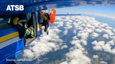 A Skydiver's Parachute Wrapped Around an Airplane's Wings.