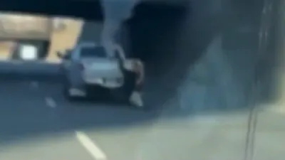 Video Shows Man Hanging From Moving Truck on Boston Highway.