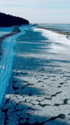 Rare Pancake Ice Forms Along Poland's Frozen Baltic Coast.