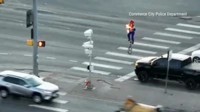 Police Drone Films Fire-Juggling Unicyclist Stopping Traffic.