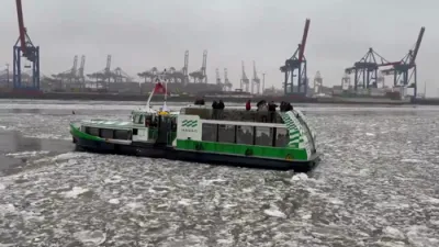 Green Ferry Battles Thick Ice on Frozen River.