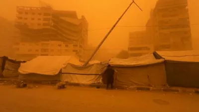 Eerie Orange Skies: Gaza City Disappears Under Massive Orange Dust Storm.