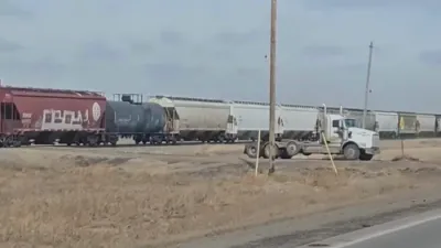 Train Rips Trailer From Truck in Violent Rail Collision.