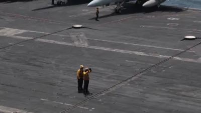 Carrier Might on Full Display: U.S. Sailors and F/A-18 Jets Roar into Action Aboard USS George H.W. Bush.