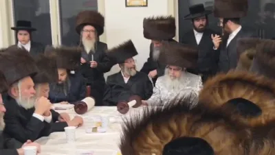 The Satmar Rebbe Shlit"a writing a letter and dancing with the Sefer Torah at the Hachnosas Sefer Torah last night, Motzei Shabbos, in Camp Satmar Maywood.