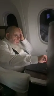 Rosh Yeshiva HaGaon Rav Salim Shlit"a Engrossed in Learning on a Laptop on the Plane, En Route to a Keren Olam HaTorah Trip in Mexico and Panama