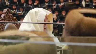 The Vizhnitzer Rebbe Shlit"a at Selichos Rishonos in the Beis Medrash HaGadol, Wrapped in a Tallis Inherited From His Grandfather, the Imrei Chaim of Vizhnitz ZY"A.