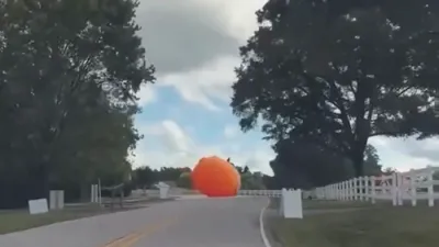 GREAT PUMPKIN GETAWAY: Storm Winds Send Giant Inflatable Rolling Down Road