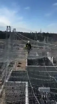 WIRES OVER THE WIRES: Russian Workers Climb High To Shield Power Site From Drones
