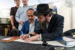 היסטאריע אין 'קאסטראמע': ספרי קודש אנטדעקט אין די ווענט פונעם בנין, און א כתיבת ספר תורה