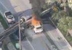 Main image for פייער באלי אויפן גאס: א דראון ווידיאו צייגט ווי א קרעין קראכט אריין אין א ווייסע SUV און פאראורזאכט א מאסיווע פייער אין די פינאנציעלע דיסטריקט