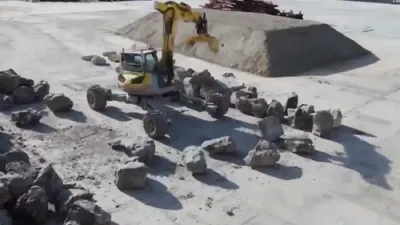 אן קיין מענטשליכע הענט: א ראבאטישע עקסקעוועיטאר בויעט א מאסיווע 65-מעטער שטיינערנע וואנט